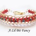 Gold and coral wrap bracelet with feather pendant