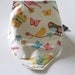 Cotton soft dribble bib in pretty birds, buttterflies and flowers fabric