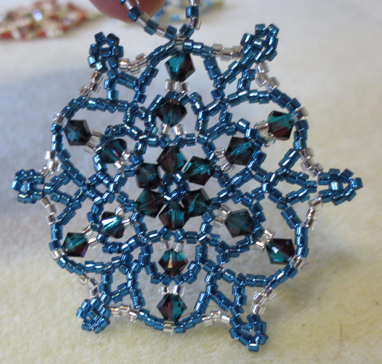 Bead and crystal snowflake / wreath ornament. Blue and silver.