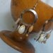 Sea shell, wood, metal feather on a hoop Earring