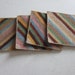 Four needlepoint coasters