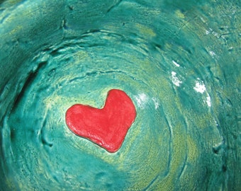 Green hart shape bowl with red hart inside..