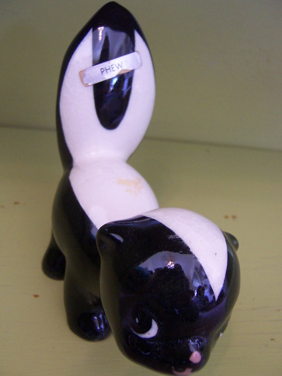 ceramic skunk figurines