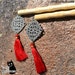 And Tassels -- 9" long hair sticks with red tassels and silver