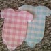Last set of 15 pink and white gingham baby onesie shower napkins