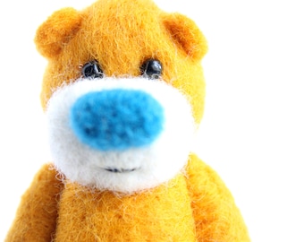 Miniature orange pocket bear with a bright blue nose