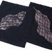 Two black cotton napkins with stenciled grid pattern