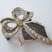 Vintage 60s Retro Regency Goldtone Gold Tone Black Clear Rhinestone Open Work Cross Hatch Ribbon Bow Brooch Pin