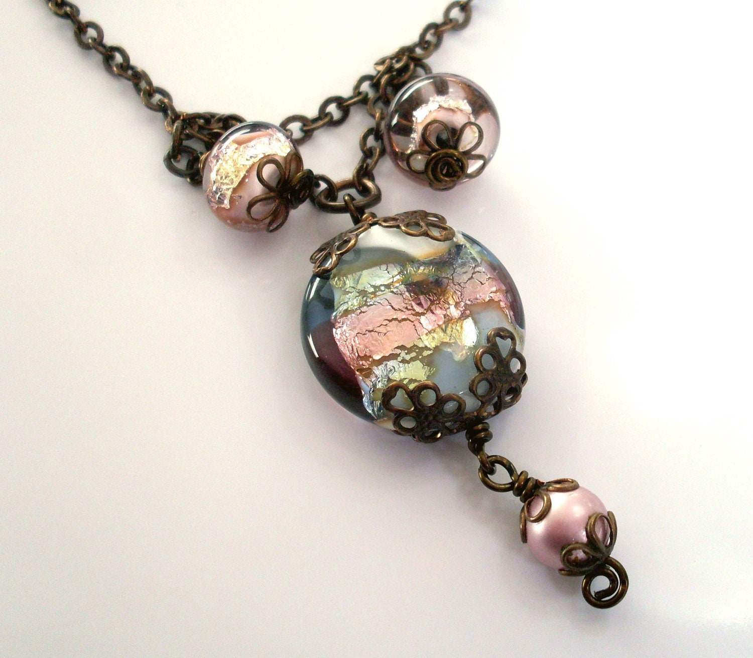 Art glass pendant necklace. Antiqued brass filigree and chain.