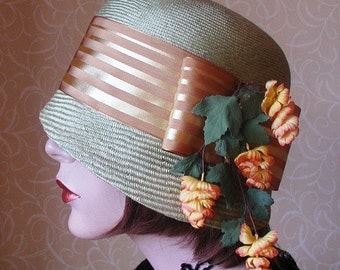 Pale green straw cloche hat.