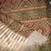 Throw Blanket in Earth Shades of Red with Brown tones, Green, and Bronze, and Features a Stripe Reverse Side