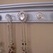 One of a kind Necklace organizer large rhinestone center with 5 total knobs on silver metallic finished wood 15 inches long