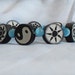 Zen Funk Bracelet - Clay black and white beads with Cat's Eye Glass blue