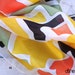 Elegant hand-painted silk scarf. orange, yellow, green and black