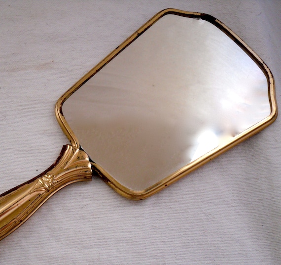 gold hand mirror