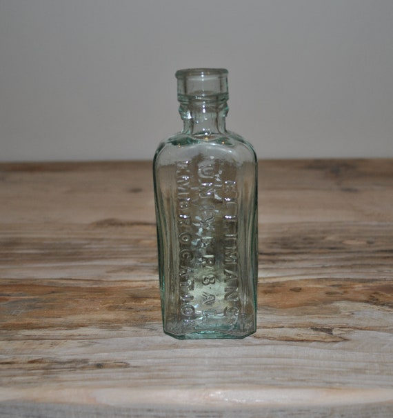 Antique aqua green tint glass bottle Ellimans Universal