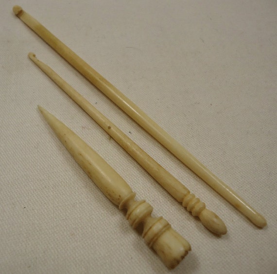 Two bone crochet hooks and an awl vintage/antique