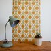1970's french wallpaper with geometric flower design in greens, browns and orange, full roll