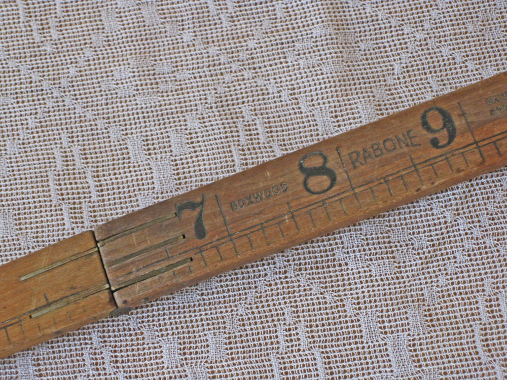 Folding wood ruler with brass hinges