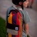 Rainbow Kid pack, striped backpack with leather (red) base.