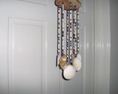 Wind chime with Clam & Whelk Shells Strung with Colored Beads on an oOblong Cedar Base Handmade