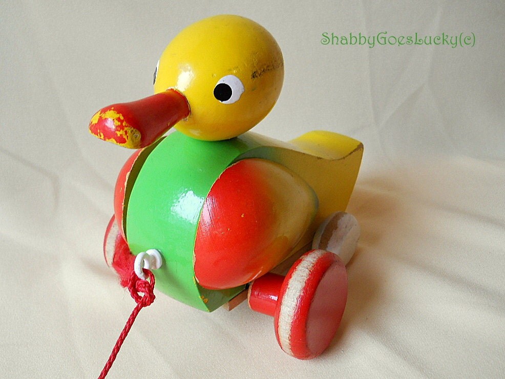 German vintage wooden pull toy quacking duck on wheels moving