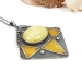 Silver wire wrapped pendant with yellow amber and gold enamel - tribal style