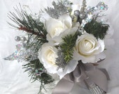 Winter wedding bouquet and boutonniere white roses silver glitter pine, green pine, and crystal gems winter wedding