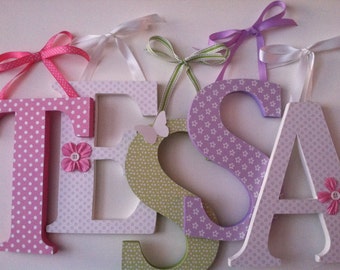 Wooden  nursery letters in  lavender, pink,  and green 