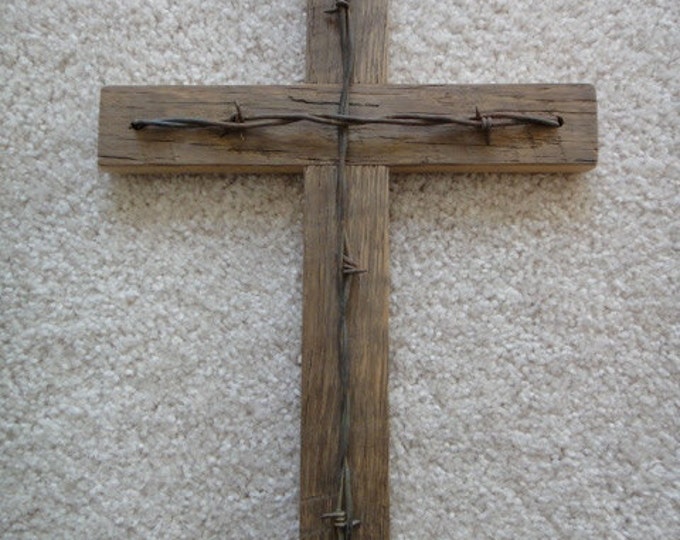 Rustic barn wood cross with barbed wire accent