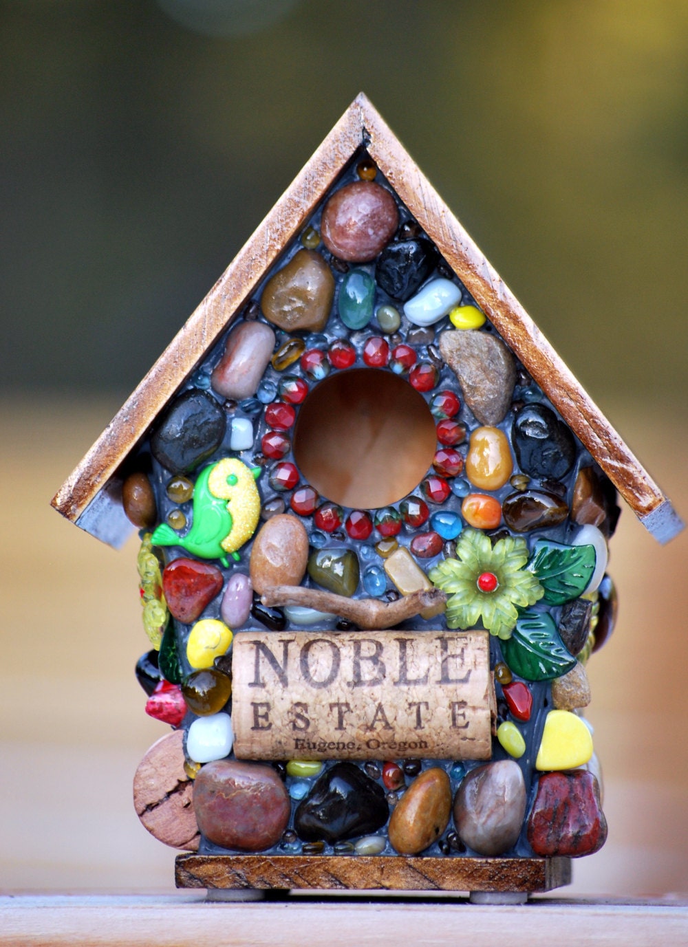 Whimsical garden birdhouse with Spring flowers and wine corks