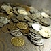 Approx 125 medium mixed gold colour aluminum coins 0.5" or 1.5 cm