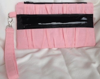 Pink gathered clutch purse with patent black band