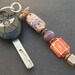 key ring chunky lampwork glass purple, orange, white and silver beads- flower power