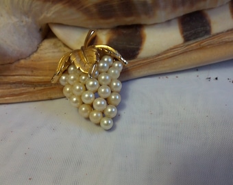 Classic Trifari grape cluster brooch set in gold tone metal and creamy faux pearls