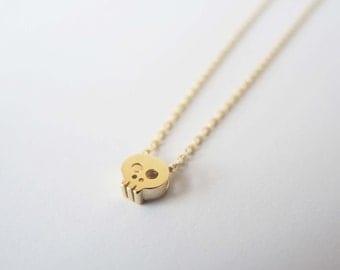 Tiny Skull necklace in Gold