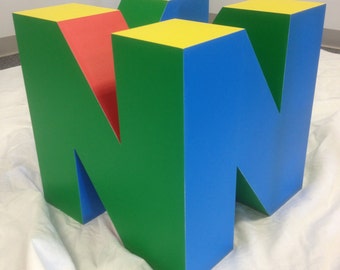 a nintendo 64 shaped and inspired bottom base for a coffee table that is unique and functional.