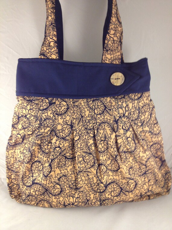 navy and gold handbag