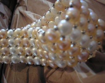 A bracelet of freshwater pearls and silver plated beads