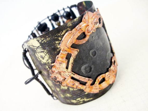 Join the Call. Salvaged tin cuff with gold leafed frame, resin paper moon, dark rustic beads.