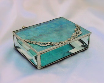 Iridescent turquoise glass box .