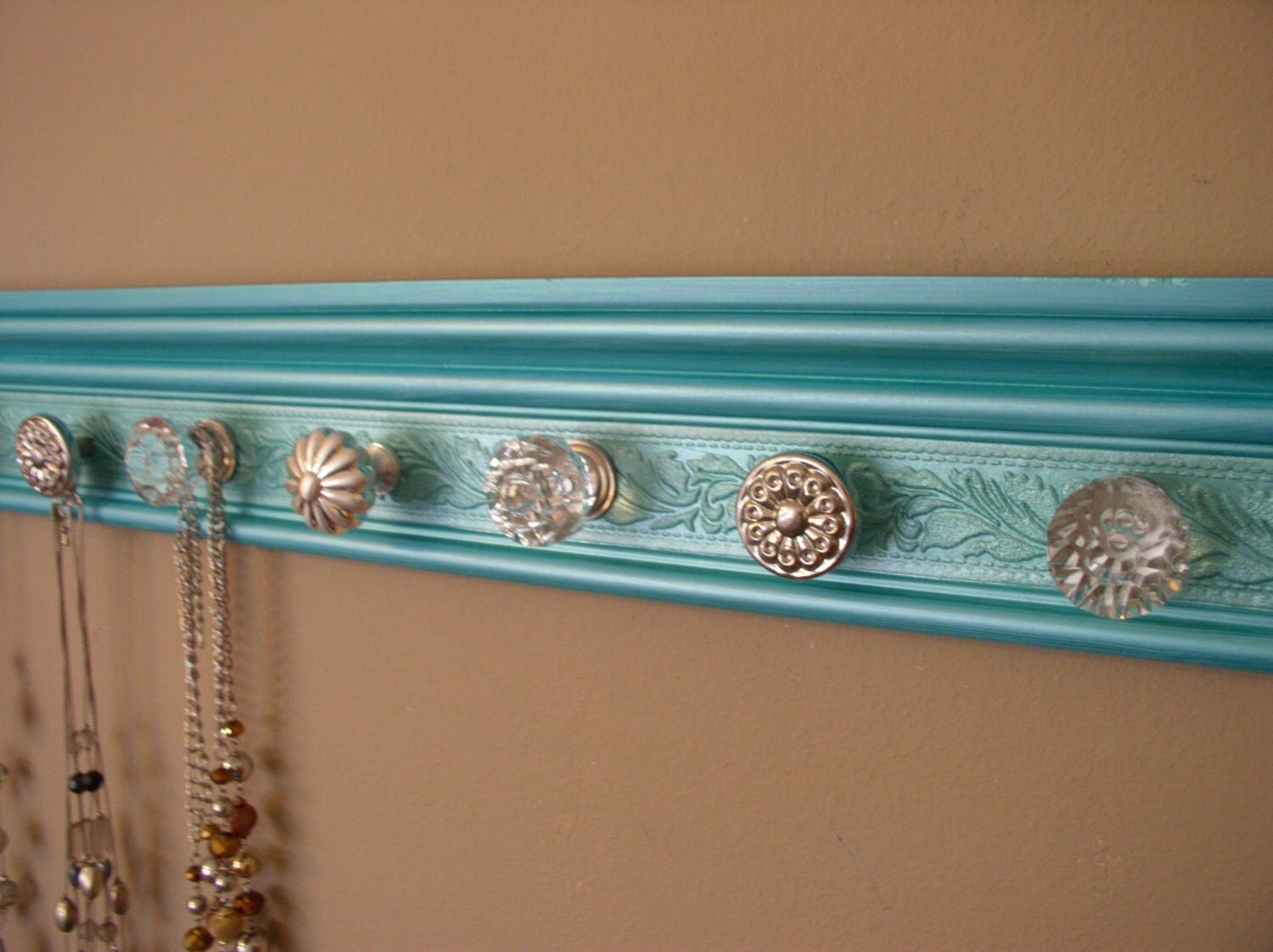 jewelry/necklace organizer with 7 decorative knobs on