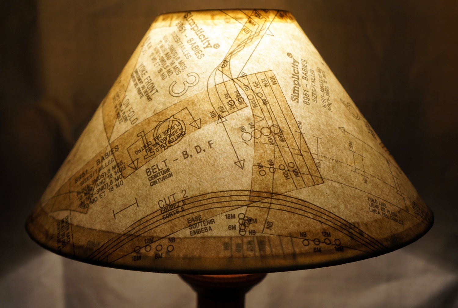 Unique lamp shade covered in vintage paper patterns gives a