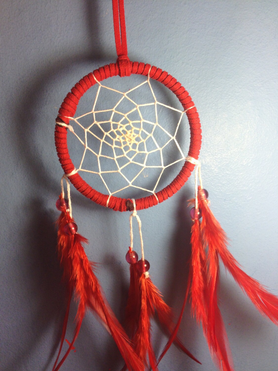 Red suede dream catcher with red feathers by dreampeacepositivity