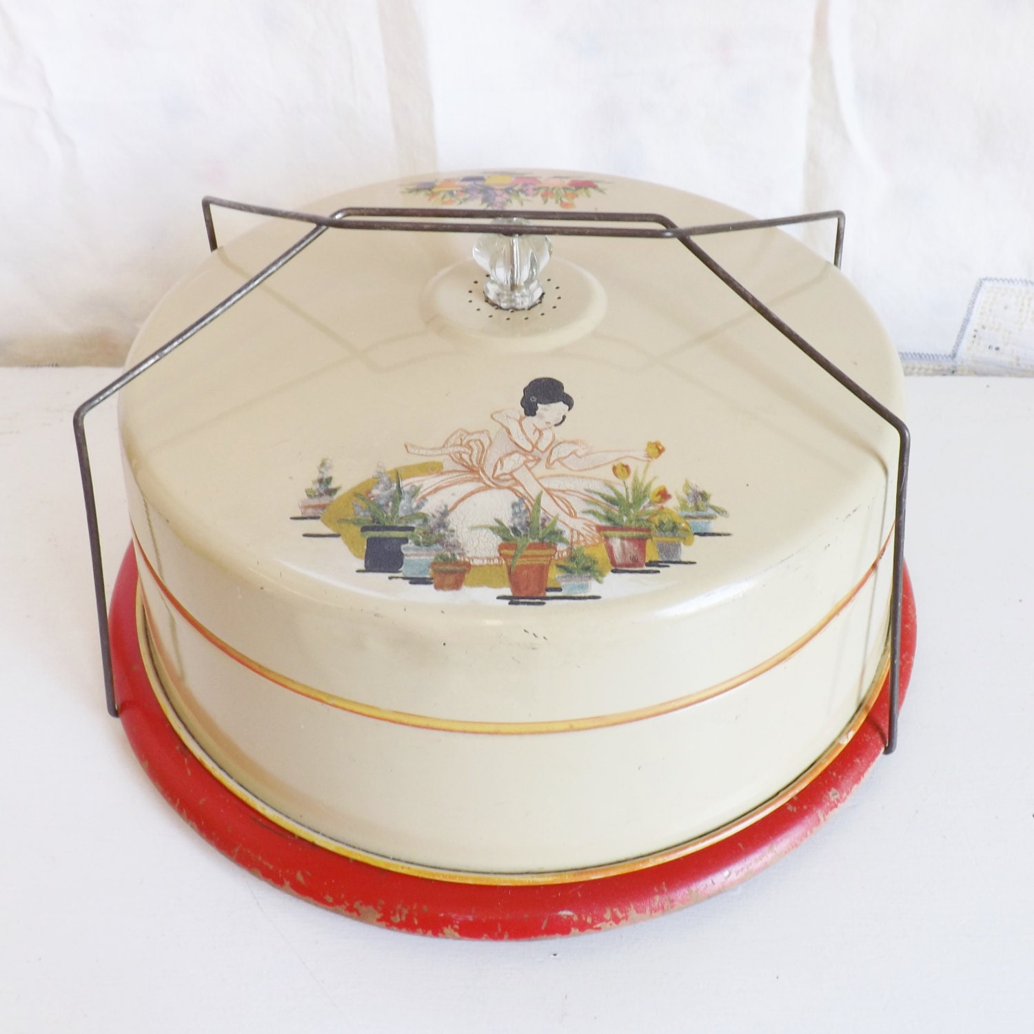 Vintage metal cake carrier with flowers and lady gardening