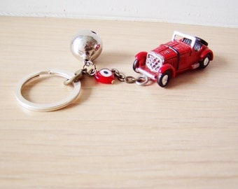 Antique car key chain with bell and eye in red or yellow