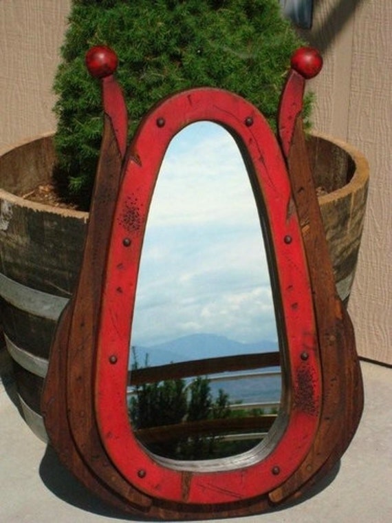 Antiqued wood horse collar mirror.Great wall decor for your