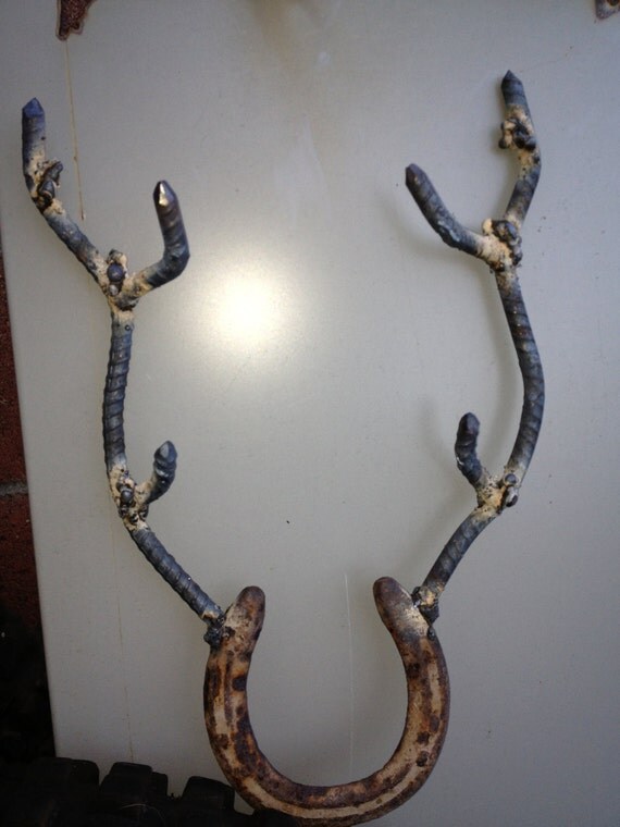 Metal sculpture...Good luck horseshoe with deer antlers