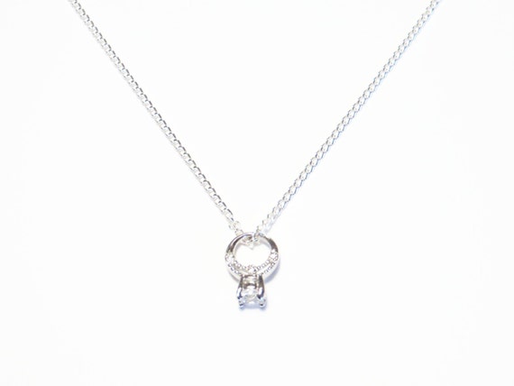 Cool wedding rings for newlyweds: Engagement ring on necklace