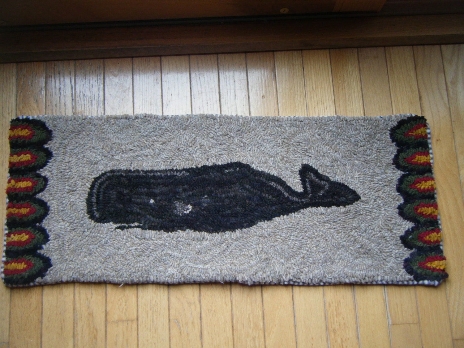 Primitive whale runner rug hooking pattern on gridded trace